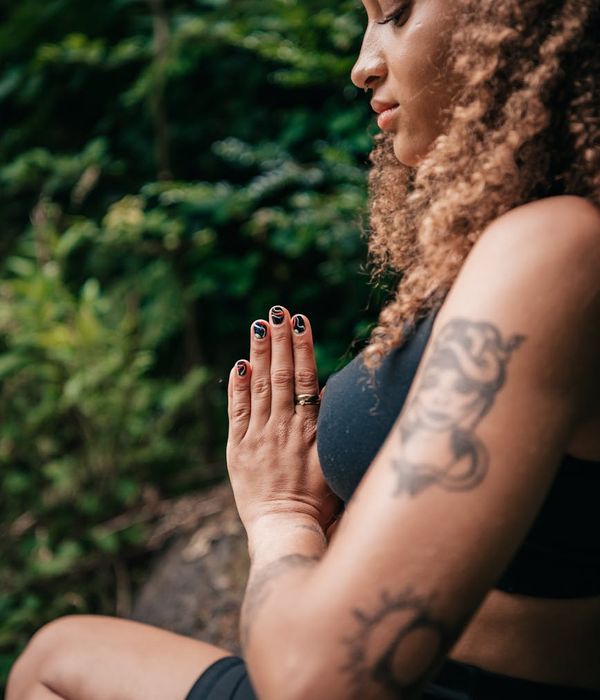 Woman in a balanced yoga pose, conveying a sense of calm and focus.